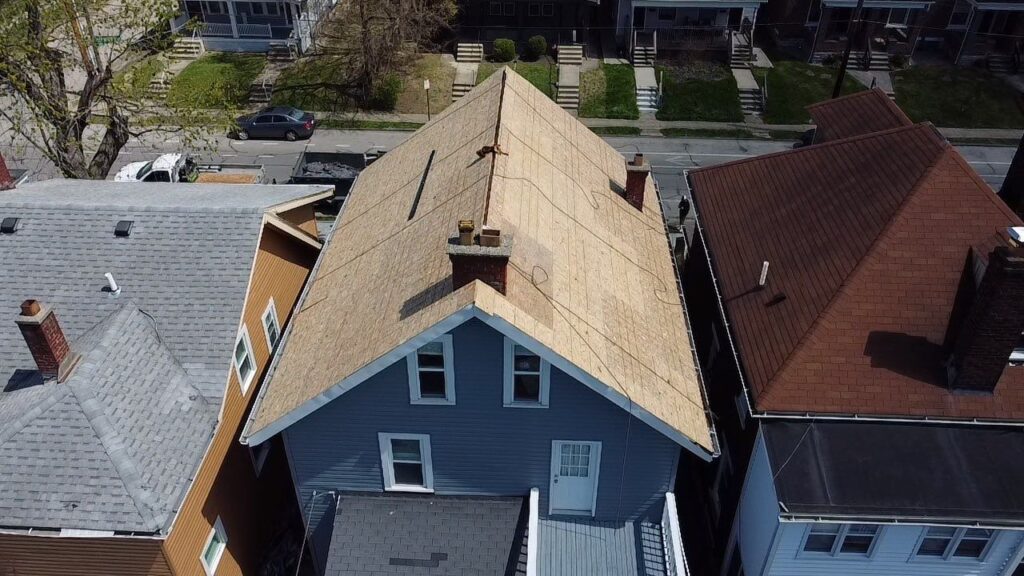 This aerial shot shows the roof after we removed the slate. Replacing it with new sheeting was necessary to ensure a sturdy surface for our shingles.