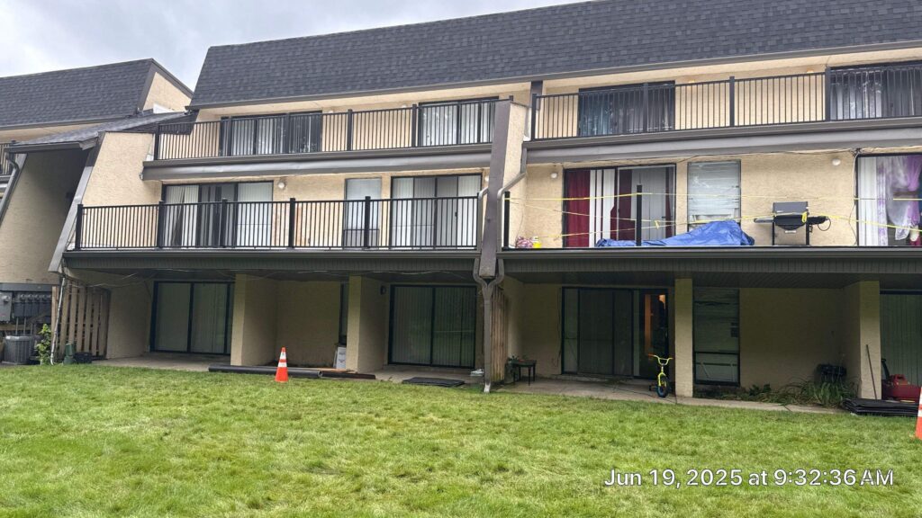 Completed apartment balcony restoration with new TPO roofing, 6-inch gutters, and rebuilt mansard shingles