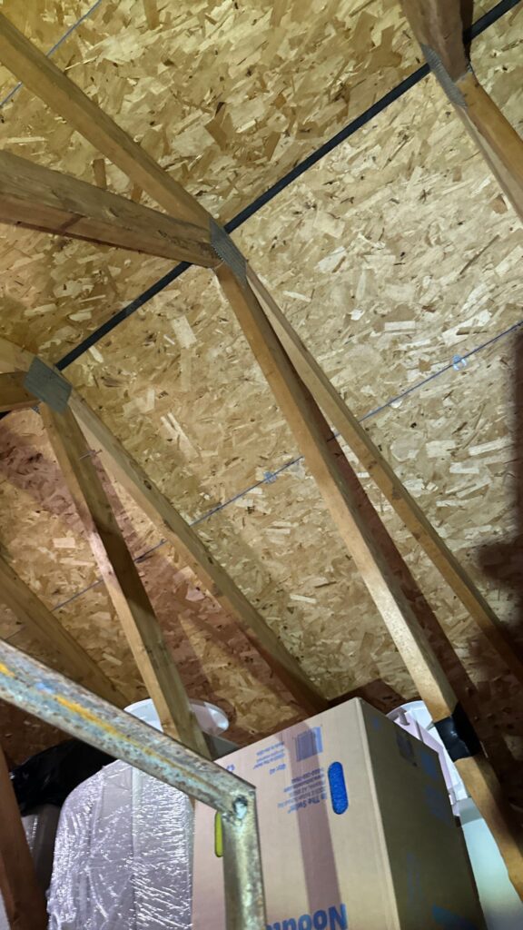 Attic inspection photo of the wood decking to confirm solid sheathing for new roof installation