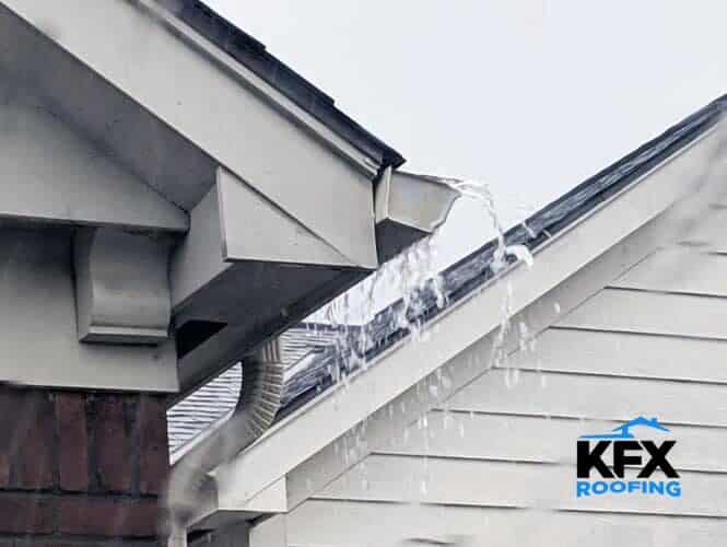 Gutter overflowing during rainstorm showing water spilling over edge at corner joint