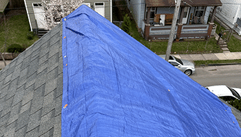 Emergency roof tarp due to wind damage that needed to be tarped to protect from further water intrusion